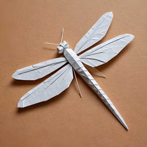 The image shows an origami dragonfly crafted from white paper. The dragonfly is facing towards the right side of the frame and has a pointed head with two antennae on its back. The wings are folded inwards at the tips, giving the impression that they are ready to take flight.